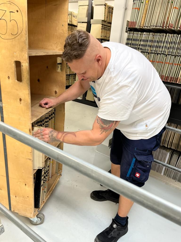 HERTLING employee places a file shelf